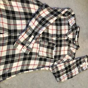 Black and white collared blouse with red stripe.